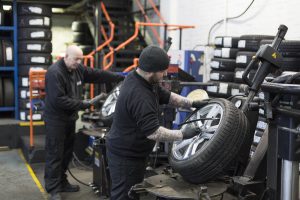Mr Tyre technicians inflating tyres