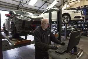 Mr Tyre technician using computer terminal