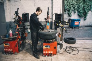 Mr Tyre mechanic setting up for tyre change