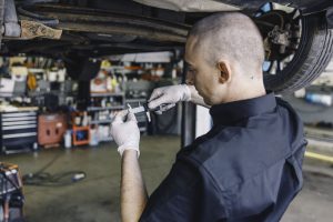 Mr Tyre mechanic performing tyre tread depth gauge
