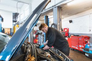 Mr Tyre Newcastle-under-Lyme technician working under bonnet