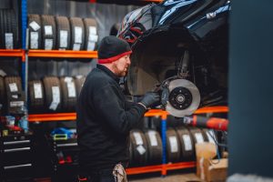 Mechanic fixing car brakes.
