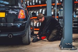 Mechanic checking tyre pressure.
