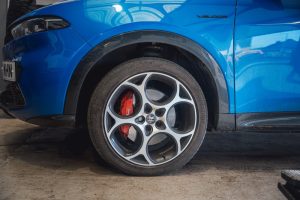 New tyre fitted on blue Alfa Romeo car