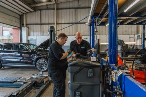 Mechanics at Mr Tyre Rochdale carrying out car checks on a computer.